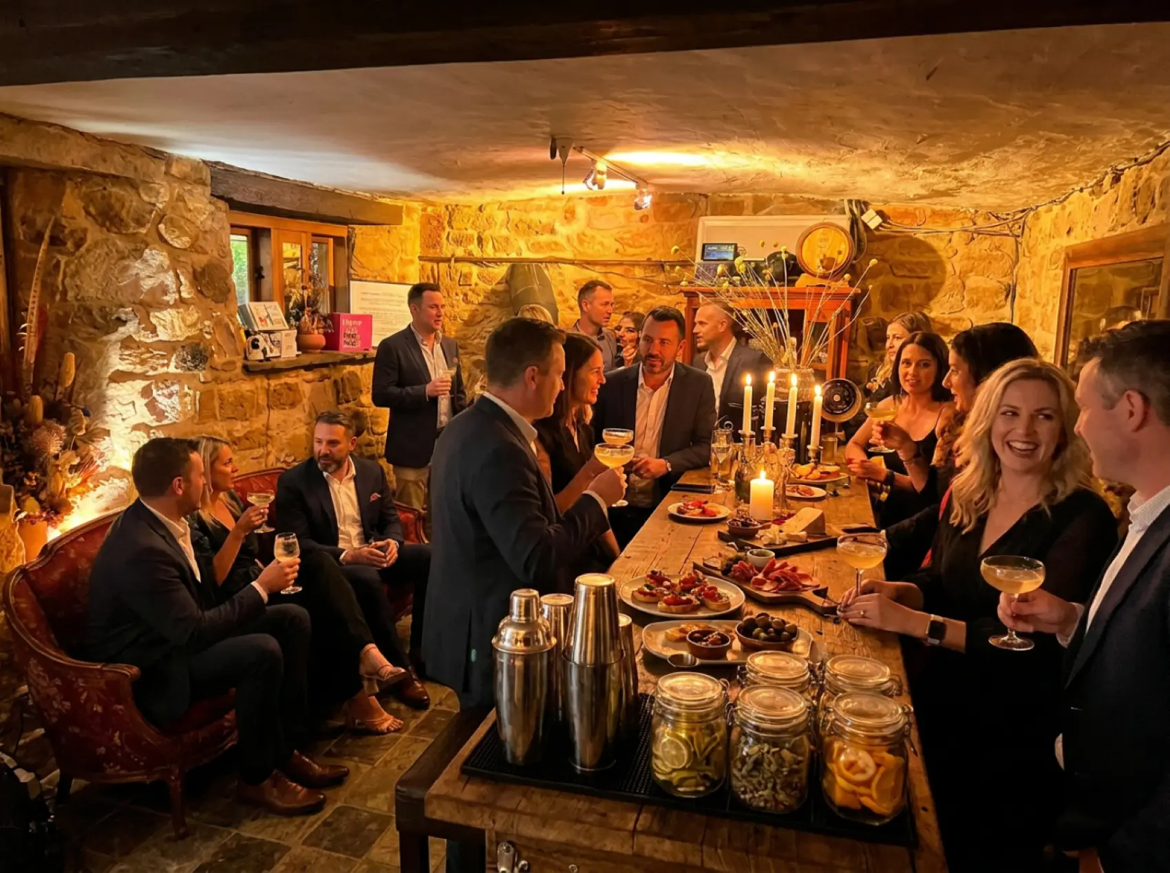Guests toasting around a long table in the stone cellar at Jeanneret Rd